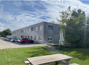 A building with a parking lot and a parking lot

AI-generated content may be incorrect.