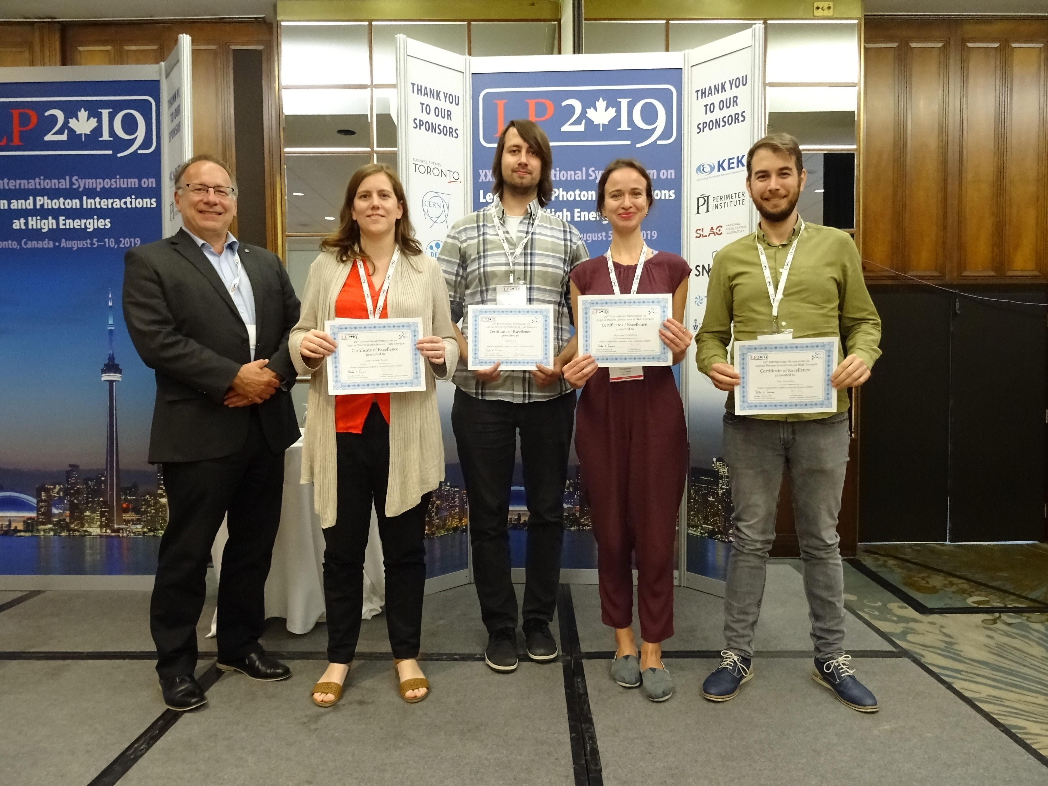 The winners of the Lepton Photon Poster Competition from left-to-right:  Prof. Michael Roney, Director of the Institute for Particle Physics; Dr. Carla Marin Benito, Mr. Robert Les, Ms. Krystsina Petukhova and Mr. Jose Soto-Oton.